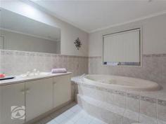  13 Peppermint Cl Greenwith SA 5125 $530-550,000 Located in heart of Petworth Lakes, this spacious Family Home has three separate living areas with views of rolling hills and glorious sunrises. Four Bedroom home, double doors leading to main bedroom, walk in robe, ensuite consisting his and hers vanity unit, plus two person spa. Bay window formal lounge/dining with vaulted ceilings. Large kitchen providing ample bench/cupboard space and walk in pantry. Light bright family room and casual meals opens to separate games room via double doors. Both family and games room have sliding doors leading to verandah entertaining area and low maintenance gardens. Bed two and three are both double bedrooms with built in robes to bed three and four.  Neutral decor, down lights, high gloss floating floors and new carpet give home wow factor. Ducted reverse cycle air conditioning provides all year comfort plus Solar Panels. Located in one of Petworth Lakes best streets surrounded by other quality homes with reserve/playground and Duck filled lake a short stroll. Woolworths, Chemmart, BWS and specialty stores at trendy recently completed The Stables Shopping centre. Greenwith and Our Lady of Hope primary school/kindergarten are all conveniently located close by. Additional information Property Type House  Property ID 11115117533  Street Address 13 Peppermint Close  Suburb Greenwith  Postcode 5125  Price $530-550,000  Council Zoning GGR  Living Area 247 sqm (approx)  Land Area 603 sqm (approx) 