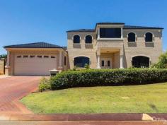  19 Carlton Turn Currambine WA 6028 $875,000 to $915,000  THE ULTIMATE FAMILY HOME! Sensational in quality and presentation, this beautiful Beaumonde built home features superior fixtures and fittings throughout. Porcelain tiled floors and impressive pillars line the entry way, while the formal lounge and dining rooms are graced with solid polished Jarrah flooring, stunning crystal chandeliers and quality window treatments. Hidden behind French doors is a home theatre room, which is fully equipped with projector, screen and surround speakers. The large kitchen boasts an abundance of cupboards, drawers and large granite bench top. French doors lead through to a games room and access to a private conservatory and sitting area that overlook the glistening below ground solar heated pool. The three bedrooms on the lower level are all king size and have their own split system A/C, as well as double built in robes. Upstairs you'll find a king size master bedroom which features polished Jarrah flooring, a huge walk in robe and stylish modern en suite. There is also a large parent's retreat/study area complete with fully contained kitchenette, ocean glimpses and inland views from the private enclosed balcony. This stunning home has to be seen to be fully appreciated.  Features include, but are not limited to:  -Views overlooking Carlton Park  -Ocean glimpses from second level  -Porcelain tiled flooring  -Polished Jarrah flooring  -Crystal chandeliers  -Abundance of storage space throughout to suit your needs  -Home theatre with projector, screen and surround sound  -King size master bedroom  -Amazing walk in robe, fitted with mirror  -Master en suite with marble top vanity, corner spa, shower and separate WC  -Three king size bedrooms, all with double built in robes  -Two bedrooms have access to family bathroom  -Family bathroom with corner spa, shower, marble vanity top and separate WC  -Split system units in all bedrooms and family area  -Large laundry with bench and storage  -Sound surround throughout most of the home  -Wrought iron balustrade with wooden handrail on entrance staircase  -Large kitchen with shoppers entry, quality stainless steel appliances, range hood, walk in pantry,  Granite bench tops and double fridge recess.  -Security camera on porch  -Remote control lockup garage with workshop area  -Garden shed  -Beautiful Kidney shaped below ground, solar heated pool, complete with waterfall  -External shower  -Undercover alfresco area  -Outdoor BBQ gas point  -Solar Panels  -Close to local schools  -Easy access to schools, public transport, shopping centres and cafes  -Large 905m2 block  -Built in 1999 PROPERTY DETAILS $875,000 to $915,000  ID: 355840 Land Area: 905 m² 