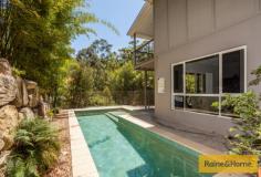  19 Grove Creek Cl Reedy Creek QLD 4227 Surrounded by nature Property ID: 9232061 Upon entering this home the hardwood timber floors create an immediate warm and inviting ambience and lead you to the ground level living spaces and bedrooms. Entering the large living/dining area one can only be impressed by the soaring raked ceilings and large windows with 180 degree views of the bush canopy.  This home is positioned to capture the cooling breezes channelled up the adjacent valley and is supplemented by split cycle air conditioning which cools the whole home and enhances your year round comfort. Adjacent to the open plan living/dining is the spacious chef’s kitchen with stone bench tops, quality stainless steel appliances and ample bench space plus a butler’s pantry to make sure entertaining on a grand scale is accomplished with ease. The living/dining area opens to the large rear verandah which gives you plenty of room for alfresco dining under roof whilst enjoying views of the nature reserve beyond … let the birds provide the music! To the left of the entrance is internal access to the auto double lock up garage and just beyond this is a good sized study/ home office with a lovely view over the pool and nature beyond. To the right of the entrance is a Media/Library or 2nd living area, two large bedrooms with mirrored robes, served by a 3 way bathroom with quality fixtures consisting of a large bath and shower room with vanity and large linen cupboard, separate toilet and separate vanity area serving the wc.  Timber stairs lead downstairs to a fully tiled rumpus room which opens to the huge patio area and overlooks the swimming pool so you can keep a keen eye on all. Behind the rumpus is a guest bathroom and a large family laundry. To the right down the hall is a guest bedroom then a private master suite with a generous ensuite with separate powder room. Walk through the Harry Potter door under the staircase to the huge workshop and storage area, perfect for wine cellering or for the handyman. You wont miss the 10,000ltr water tank down here either. This workshop area also has side access. Below the house is the terraced garden comprising a modest orchard of fruit trees, vegie plots and Australian natives planted abundantly to bring the native birds into the property. This is a contemporary style home with nature abounding and offers a tranquil lifestyle to enjoy and unwind with your family and friends. The “Observatory” is an award winning Stocklands estate with parks and play areas to explore and with views which capture the Surfers Skyline and beyond to the Pacific Ocean. This home is at the foothills and is only minutes away from shops, schools, rail & M1. This is the first time this home has been offered for sale as the owners are downsizing and have purchased close by. They are hoping you too will love the ambience of their home and the aviary in which they live. We look forward to your successful private tender before its close on 19th February 2016 by 5pm. 
