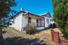  61 Elwick Rd Glenorchy TAS 7010 $259,000 + Good looks at a beautiful price This spacious weatherboard home built in 1900 still retains some of the original period features which gives the home real heart. Wide hallways, a decorative archway and ceiling roses, deep cornices, picture rails, fretting and a stained glass front door are just some of these features. And although the house is positioned on Elwick Road it is tucked in a side street hidden by a treed nature strip, making it feel more secluded and private. The large master bedroom has good sized built in robes and access to a large and light two way bathroom boasting a corner spa. The second bedroom is also a good size and has a feature fireplace. The 3rd bedroom or office, fitted with a skylight, opens onto a spacious hallway and could be an ideal play area or an extra sitting room. The very generous open plan kitchen, dining and lounge area enjoys the morning sunshine and would be a pleasant place to have breakfast, either at the breakfast bar or kitchen table. The polished floorboards make the room feel warm and there's a wood heater for those cooler months plus a heat pump for convenience. And the positives continue outside as the lounge opens onto a generous undercover barbie area, perfect for year round entertaining or a great place for the kids and pets to play in the fully fenced backyard. The laundry is also located in this area and another toilet which is very handy if you're entertaining. The garden is very low maintenance but would also be ideal for an avid gardener. There is plenty of off street parking and could even house a smaller caravan or boat. The 30m2 garage would transform into an enviable workshop or 'man cave' or both. It would also make an excellent family home and given its proximity to schools, shops and transport, abundant off street parking and storage coupled with the beautiful features this is a very tempting property at a very affordable price.   Property Snapshot  Property Type: House House Size: 119.00 m2 Land Area: 713 m2 Features: Built-In-Robes Close to Schools Close to Shops Close to Transport Heating 