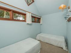  75-77 Tramican Street Point Lookout QLD 4183 $2,300,000 Both blocks are a total of 1,800m2 and have wonderful beach, bush and ocean views. The large architecturally designed house has a two car lock up garage at street level which links to the house with a timber walkway. The garage building has a large loft area - perfect for a craft room, office or even a separate studio bedroom and lockable storage areas underneath. The main house has two levels with all living areas on the top level.  There is a formal lounge area on entry, large open plan kitchen with walk in pantry plus formal dining - all opening onto a covered deck. There are two bedrooms and a bathroom on this level also.  The bottom level has three more bedrooms including the master bedroom with walk in robe and en suite bathroom, a second bedroom also has an en suite with spa bath and there is a small bunkroom The separate laundry with large storage area (perfect for a wine cellar) has direct access to the garden. 
