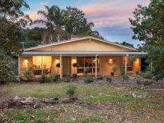  44 Bollen Rd Mt Barker SA 5251 $575,000-$610,000 Soul Inspiration! Property ID: 9494721 An inviting residence with a warm ambiance, architecturally designed with lofty raked ceilings and spacious living. One proud homeowner has lovingly created a homely environment, which also exudes style and taste. The rendered Tuscan-ranch style facade offers fantastic street appeal, with fully lit front verandah. The large English Oak provides excellent shade from the afternoon sun, and the double carport takes care of off-street parking.  You will certainly experience a “WOW” moment upon entering the home, as you cast your eyes over the parquetry flooring, and gaze past the family room to the sunny glass conservatory. The solid timber kitchen has been completely remodelled, now featuring new stainless steel oven with gas cook top, new dishwasher, pantry cupboards, freshly tiled splash and appliance hutch. Linking is the meals area, and there are handcrafted Western Red Cedar French doors leading outside to the private alfresco patio. The central family living is as cosy as a cow in cashmere, with new Masport slow combustion log fire, and fire surround featuring stunning travertine tiling. A highlight of the family area is the adjoining light and bright conservatory which could be utilised as a music room, creative area or home office. Featured again are three sets of quality Western Red Cedar French doors. The third living zone is the dining room located at the front of the residence, offering new pure wool carpet and double glazed windows. The main bedroom links with the conservatory, and offers ensuite bathroom and walk-in robe. There are three bedrooms, one of which is utilised as an office and has built-in robes. The main bathroom offers bath, shower and toilet; there is also a third toilet alongside the laundry. Experience the tropics in Mount Barker – take a splash! Or recline on your floating couch. Either way, you know that you will be the envy of your friends as you show off your in-ground pool with landscaped surrounds, including a paved undercover entertaining area and elevated timber viewing deck. Take a sip of your cocktail and smile. A great offering with a unique architecturally designed home, presented to please. Welcome home. Building / Floor Area 	 221 sqm Land Area 	 940.0 sqm 