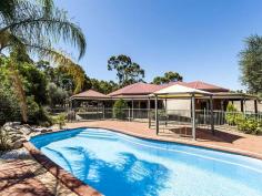  880 Stanwix Pl Wooroloo WA 6558 $699,000 SOMETHING FOR EVERYONE Located near the end of a quiet cul de sac, sits this stylish brick 3x2 home with study upon a mostly cleared, arable 28 acres (approximately). Together with a below ground pool, shed, large workshop and dressage arena there is something for everyone. The hub of this home is the central open plan living with high ceilings and consisting of tiled kitchen, meals and family areas which look out through the patio to the front garden and below ground swimming pool beyond. The master bedroom is a good size with WIR & ensuite and the secondary bedrooms are double sized, each with built in robes. The study could be used as a 4th bedroom. Air conditioning is ducted throughout and an instant gas hot water system services the house. A small rain water tank is connected to the house. Towards the front of the house is a patio that leads to the pool and gazebo. This area is fenced off from the rest of the property. Situated behind the house is a large open faced shed behind which is a small fenced arena. A large powered workshop approximately 22m x 6m with a 12m x 5m extension is close by. Attached to this is a small rain water tank. The land is fenced into paddocks suitable for a range of stock. Mostly cleared with small copses of trees, there are several dams and the added bonus of being connected to scheme water. FEATURES • 	 3x2 brick / colorbond home plus study • 	 Open plan living with high ceilings, tiled floors & s/c fire • 	 Master bedroom with bay window, WIR & ensuite • 	 Double sized secondary bedrooms with BIRs • 	 Ducted air conditioning • 	 Below ground swimming pool & gazebo • 	 Patio & verandahs • 	 Open faced shed approx. 16m x 6m • 	 Powered workshop approx. 22m x 6m with approx. 12m x 5m extension. • 	 Fenced arena and several fenced paddocks • 	 Small rain water tanks • 	 Scheme water connected • 	 Approx. 28 acres arable land with pockets of mature gums • 	 Fenced, mostly cleared undulating land with valley views • 	 Access to riding trails • 	 Several dams • 	 Approx. 30 km to Mundaring, 50 km to Midland & 55 km to airport Be quick for this one. Call for more details or an inspection. Other features: Built-In Wardrobes,Study, Connected to Scheme Water, Large Shed Property Details Elders Property ID: 9372989 3 bedrooms 2 bathrooms 6 car parks Land Area 28 acres Car Parks: 2 4 car garage Swimming Pool Air Conditioning 