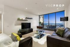  4208/1 Queensbridge Square, Southbank VIC 3006 Unique Opportunity for Top Level Living! Prime position above Melbourne’s Arts and Cultural precinct with all the CBD has on offer, this breathtaking two-bedroom residence with an enormous internal space is a combination of modern designer style and awe-inspiring views. Nestled in the bustling hub of Southbank’s food district, with Southgate shopping, Crown Casino, trams and Flinders Street Station all at your door. This chic city apartment comes well-appointed with elegant modern charm and finish. Enjoying an abundance of natural light and sweeping 270-degree views, across the city and Port Phillip Bay. This stunner is highlighted by: • 	 A vast open lounge and meals zone • 	 Marble kitchen with breakfast bar • 	 Stainless steel SMEG appliances • 	 Sizeable master retreat with an ensuite and mirrored WIR • 	 2nd bedroom with fitted BIRs • 	 Central bathroom with Euro laundry facilities • 	 Ducted heating and cooling Features: • 	 2 secure car spaces and 1 storage cage • 	 24/7 concierge and secure intercom • 	 Full sized swimming pool, spa, sauna, gym, massage rooms and theatre • 	 Garden with BBQ facilities • 	 Access to 40th floor Skyline Club 