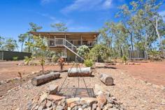  136 Mocatto Rd Acacia Hills NT 0822 $659,000 PERFECT THE WAY IT IS This property is perfect the way it is and only 2 years young. Quiet and tranquil in its bushland setting, this elevated home is sleek and modern with a great lifestyle aspect to it. Be enchanted by the relaxed abode and bask in the solidarity of living rural.  The property itself is nestled on 20 acres of land that is securely fenced with dog proof fencing and natural bush plus there is a large fenced yard around the home. The home is elevated up above the tree line and enjoys bushland views from the front and rear balconies. Sitting here you can entertain or unwind and enjoy the absolute peace and quiet. The rear deck has a built-in bar from which you can look down over the fire pit below or out over the paddocks. Inside the home has tiled flooring with an open plan central living, dining and kitchen area that are all light and airy. The kitchen is sleek and modern with a country chic feel. Wrap around counters in a bamboo look finish add in a homely touch to the white on white cabinetry.  The master bedroom has glass french doors that opens onto the balcony plus enjoy an ensuite and his and hers walk-in wardrobes. Two more bedrooms reside on this level and each is complete with built-in wardrobes and air conditioning. Downstairs is an additional forth bedroom with a bathroom and the laundry amenities.  Under the home is an expansive entertaining area with a 6-seater spa and a BBQ area that looks out over small manicured gardens with the fire pit area at the rear. Parking cars and boats is not a problem, you can fit 2 or more under the home. Included in the sale is a 40 foot sea container, a gun safe, the above mentioned spa plus a 25,000L water tank. There is a strong bore on the property as well.  Close to Humpty Doo, Noonamah and Berry Springs amenities plus approximately 30 minutes to Palmerston CBD. Neat and tidy, this home requires no improvements - it is perfect the way it is. Property Details Elders Property ID: 10173938 4 bedrooms 3 bathrooms 2 car parks Land Area 2 hectares Double carport 