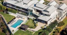  16 Old Ferry Road,  Banora Point NSW 2486 "THE COVE" - Award Winning Contemporary Masterpiece Sweeping 180 degrees ocean and hinterland views from Fingal to Byron Bay Lighthouse with meandering waterways dominate from almost every room of this spectacular four bedroom contemporary masterpiece. Designed by renowned Noosa architect Paul Clout and constructed by award winning Hammerhead Builders, this extremely spacious home offers a wonderful sense of relaxed comfort. The main expansive living area incorporates an award winning kitchen with Butlers kitchen (designed by Lee Hardcastle) which flows to the outdoor entertaining area comfortably warmed by sensored heating. Below sits the resort style pool and gazebo against mature landscaped gardens. Also on this level are two private en suite guest rooms, a well appointed office and generous dual entertaining areas with a fully insulated wine cellar. Upstairs a floating glass bridge leads to a magnificent master suite, complete with an enviable custom designed walk-in robe and bathroom featuring floor to ceiling marble and a free standing marble bath positioned to take the coastal views that stretch to the horizon. The second en suite bedroom is equally opulent with its own study and private covered deck set against a lush garden backdrop. The north wing has an intimate second living area with Calcutta marble fireplace. Throughout natural stone walls, travertine external paving, spotted gum flooring, copper downpipes, custom cedar windows and bi fold doors cap a truly remarkable residence built with attention to detail, highest quality finishes and craftsmanship, functionality and complete privacy. This iconic residence is ready for the discerning buyer who seeks an exceptional residence. * Two Master Suites with marble Bathrooms and large Dressing Rooms * Heated flooring to En suite, Villeroy and Boch fittings * Glass walling in Showers, automated Window Coverings * Fully sound proofed 10-seat home Theatre * Intergrated master Kitchen with Butlers second Kitchen-Pantry * Sports/Pool Room and Putting Green * Resort-style Pool, BBQ area, Gym with Steam Room * C-Bus technology and ducted Air Conditioning 