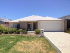  11 Arnside Bend Waikiki WA 6169 $400,000's QUALITY LIVING IN HARRINGTON WATERS! This well cared for property located in the heart of Harrington Waters would be hard to beat for any family looking for a large home in the area. A short walk to the picturesque lake and local primary school, this property is also conveniently located close to public transport and the Waikiki Village Shopping Centre. Upon entering the home, a long hallway runs through the centre of the home with a spacious theatre room on the right and a separate wing encompassing the minor bedrooms and large activity area to the left. Two of the minor bedrooms offer a double built in robe, while the third boasts a walk-in robe. The activity area sits between the bedrooms and could easily accommodate multiple desks to be utilised as a study or as a play area for young children. Progressing further into the open plan living space you will be impressed with the high ceilings and large kitchen that overlooks this central family area. The kitchen is well appointed with 900mm appliances including a five-burner gas cooktop, electric oven, stainless steel range hood and stone benches with soft close drawers as well as overhead cupboards for additional storage. Hidden from view of the main living area is a large fridge recess and huge walk in pantry, both great for keeping supplies for largest of gatherings. The beautiful master suite is located at the rear of the property and has a lovely outlook over the rear landscaped gardens. This bedroom also features a large walk in robe and a good size ensuite with oversize shower recess and closed off WC. To the rear of the property, the large paved alfresco overlooks the reticulated and landscaped gardens. The garden's central feature is a fig tree that provides shade as well as fruit offering a peaceful area to enjoy this garden all year round.  Other features include:  - 2013 built, Summit - 196m2 of living space with the 263m2 of total house area - reverse cycle ducted air-conditioning - quality timber laminate floors throughout - high ceilings - roller shutters This property has been well maintained by the original owners and is ready for the next family to enjoy this great home in a superb location. Contact David Parlor on 0412 734 727 to secure your private viewing today. 