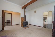  28 Hovea Cres, Wundowie WA 6560 It’s the little things that make a big difference in this modest three bedroom one bathroom home, like gleaming, newly polished Jarrah floorboards and high ceilings that create a sense of space and comfort. It also features a large retro kitchen, two cosy living areas, a carport/shed and rear access to this 1,012sqm block, which is in easy walking distance to all of the town’s major amenities.  3 bedrooms 1 bathroom  Modest fibro home  Spacious retro kitchen  Cosy living room, s/c fire  Lovely refurbished lounge  Polished Jarrah boards  Elevated timber porch  Detached carport/shed  1,012sqm rear access blk  Walk to school, shops, park  The main open living area is carpeted with a central slow combustion fire that efficiently warms the whole house and a rustic timber bar in the corner. Gleaming polished Jarrah floorboards in the recently refurbished formal lounge room are paired with high ceilings, large street-facing windows and a built-in electric heater to provide a comfortable secondary living space.  The ample, eye-popping orange-yellow benchtops, timber-look cabinetry and Metters wood stove give the surprisingly spacious kitchen a cool retro vibe. It also has a freestanding electric oven and cooktop. The rear sleep-out houses the laundry, a bathroom with separate toilet off to one side and a third bedroom. It has a sliding door into the large carpeted master bedroom. Bedroom two is off the living room and has a robe alcove and Jarrah floorboards.  Watch the world go by from your seat on the elevated front timber porch or entertain out the back under the verandah, which spills out to a brick paved area adjacent to a shadehouse. There is a single carport/shed at the end of the side driveway and a few additional structures in the large yard, which has rear access off Leschenaultia Road. This is a great location in easy walking distance to the shops, school, sports ovals and so much more.  Wundowie is one of the first true country towns on the eastern fringe of the metropolitan area and as such contains all the essential services needed for a self-supporting community, including a primary school, police station, medical centre, ambulance station, fire brigade, community centre, library, post office, day care, fantastic sporting facilities and more.  There’s no denying this property has been cared for. It has good bones, some great features and is incredibly affordable. So if you’re looking to get started with your own home or you’re looking for a smart investment, don’t ignore this great opportunity.  To arrange an inspection of this property or for a no fuss, fair dinkum approach to local real estate call ‘True Blue’ local agent Sam Blackwood on 0408 308 360.  BE SEEN - BE SOLD - BE HAPPY  Do you want your property sold? For professional photography, local knowledge, approachable staff, a proven sales history and quality service at no extra cost call the Brookwood Team. 