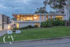  61 Sydenham Road, Doubleview, WA 6018 RARE-TO-MARKET MID-CENTURY MASTERPIECE Iconic properties such as this rarely change hands - this one has had just three owners since it was built in the 1960s.  Offering a dramatic first impression with its cantilevered terrace, white-rendered facade, graceful eucalyptus trees and vast sweep of lawn, it reveals itself as a beautifully realised example of mid-century modernism, reminiscent of the glamorous homes of LA and Palm Springs.  The floor plan makes the most of elevated city views from the deep tiled terrace and formal living room. At one end of the adjoining family room is the near-new kitchen with sleek, contemporary finishes, a scullery, and restful long views, making it a space that is open and enjoyable to cook in.  The home's four bedrooms are conveniently separate from the living areas. The main suite has an ensuite, plus a balcony looking out over the street through eucalyptus trees. Three more bedrooms run along a separate wing and share a family bathroom with simple stone tiling, a deep tub and a separate shower. The home's hallways and living areas feature a gallery hanging system for displaying art work.  The back of the house wraps around the home's amazing freeform swimming pool. Surrounding stone tiling and timber decking provide plenty of space for relaxing and enjoying the views of the glassy blue water, understated tropical plantings of palms and frangipani, and an original grotto.  Tucked away to the rear of the block is a self-contained studio, which offers the potential to extend further, adding an ensuite and kitchenette, and could also be accessed from the sealed laneway at the rear of the house, making it perfect for multi-generational living or a home office.  Beneath the house are a triple garage, temperature-controlled wine cellar and workshop, and extensive storage space, all tucked neatly away in an undercroft area.  This remarkable home is sure to appeal to fans of modernist architecture, and its proximity to the coast and location high on Doubleview hill with breathtaking views add to its appeal.  Be sure to register your interest early as history shows it won't be on the market for long!  * Rarely available mid-century modernist family home  * Four double bedrooms with built-in robes  * Two spacious linked living areas with tiled terrace and city views  * Huge freeform central swimming pool set in landscaped gardens  * Renovated modern bathrooms with stone tiles  * Three-car undercroft garage plus cellar and storage  * Two hallways with gallery hanging system for artwork  * Contemporary chef's kitchen with scullery and city views  * Established, manicured gardens front and back  * Separate breakfast room or study overlooking pool  * Elevated position on Doubleview hill  * Self-contained 32 square metre garden studio  * Close to beach, freeway to CBD and Woodlands Shopping Centre  AUCTION: 20th May 2:30pm  DEPOSIT: $100,000 due at the fall of the hammer  SETTLEMENT: 20th June 2017 