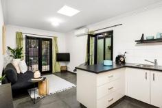 27 Manningham St, Parkville VIC 3052 Parkville prestige combines with the contemporary style of a two year old renovation to deliver this two bedroom, two bathroom city fringe abode, sure to delight investors, downsizers and those seeking an entry point into an exclusive market. Modern in design, the kitchen boasts extra wide soft-closing drawers, induction cooktop and glass/stainless steel canopy rangehood. A clever foldaway breakfast table opens up the living domain when not in use. French and glass sliding doors from the living zone and master bedroom respectively, proceed to a tranquil, easy care entertaining courtyard, basking in northerly light. A 1:1 ratio of bedrooms to bathrooms ensures the master enjoys an exclusive ensuite whilst the second bedroom accesses a spacious central bathroom incorporating laundry function with floating vanity and open shower common to both. Add to that screened property boundaries to enhance privacy within a serene, eucalypt lined plantation streetscape, surveillance cameras for peace of mind, sky lights to brighten a splendid interior and split system air conditioning for continuous comfort and the result is city fringe chic. Superbly placed metres to Royal Park, Flemington Road trams, Flemington Bridge Station and CityLink with Melbourne's university and hospital precincts, CBD and Melbourne Zoo just minutes away.  