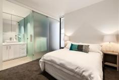  109/102 Rankins Road Kensington VIC 3031 Epitomising the ultimate in modern design and quality, this executive, as new one bedroom plus study residence within “The London” boutique apartment complex is ideally located on a picturesque tree-lined street, close to Kensington train station, Macaulay Road shopping and cafe precinct and just 4km from the CBD. Generous open plan living spills onto a large, full-width entertaining balcony via broad glass bi-fold doors, seamlessly and fashionably bringing the outdoors in. Coupled with the gourmet kitchen boasting stone bench tops, smoked glass mirrored splashbacks, soft close drawers, state-of-the-art Neff stainless steel appliances including induction cooktop and semi-integrated dishwasher, entertaining is nothing short of a dream. From the frosted glass sliding door separating the master bedroom and ensuite to the exclusive chrome fixtures, stone bench vanity and mirrored wall, the fully tiled bathroom is a statement in contemporary style. Video intercom entry and complex surveillance provide peace of mind for the security conscious, whilst split system air-conditioning ensures year round comfort. Other impressive features include secure parking bay, well-designed study nook, polished timber floorboards, storage cage, European laundry and sheer roller blinds. In a class of its own, “The London” will exceed your expectations and deliver the ultimate urban lifestyle. Features - Chic apartment featuring quality fixtures and finishes throughout - Spacious open plan living with huge private entertaining balcony - Fabulous stone bench kitchen with state-of-the-art stainless steel Neff appliances - Good sized bedroom with vogue ensuite bathroom, BIRs plus study nook - Split system air conditioning, quality flooring and great storage - Video intercom entry and undercover parking plus complex surveillance 