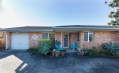  1/10A Pitt Street Coffs Harbour NSW 2450 Opposite a family friendly park and local tennis courts; this low maintenance villa in a complex of just two is perfectly positioned within walking distance to the heart of the CBD!  Brick and tile in construction; the tiled foyer provides entry into the open plan home. The galley style kitchen offers electric appliances including an upright stove plus there is internal access to the SLUG. The carpeted living/dining offers reverse cycle air conditioning and a ceiling fan. Adjoining is the north facing, fully fenced courtyard; ideal for alfresco dining. In the eastern wing of the home you will find two carpeted bedrooms both with mirrored built in robes plus the main bedroom offers a ceiling fan. Located directly between the two rooms is the bathroom and separate toilet for convenience. Additional features include: NBN connected, solar power, 250L solar hot water and inclusive laundry in garage.  This centrally located property is ideal the home for the first homebuyer, a sound asset for the Investor or the best low maintenance property for the retiree to enjoy. 
