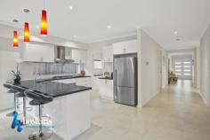  56 The Range Boulevard, Croydon, VIC 3136, Australia Glamorous Meets Grandeur $1,230,000 - $1,350,000 First class lifestyle within the elite and exclusive Range Estate.  - Proudly introducing this sophisticated residence providing approx. 48 squares in total, around two years young.  - The dynamic interior features a very impressive entrance hallway which sets the tone for the scale of this fabulous home.  - A study or home office option, lounge room, generously sized first or guest bedroom with a modern ensuite. - Designer, high end kitchen connects effortlessly with the dining and family zone merging with the spacious leisure room opening onto the covered alfresco retreat and easy care garden. A spacious Bulters pantry adjoins the kitchen. This magnificent informal zone is the heart beat of this home.  - A powder room and good size laundry completes this lower level.  - Upstairs showcases the living room with private balcony enjoying expansive views towards the Dandenongs, a stunning view enjoyed from many rooms of the home. - Offering four additional generous bedrooms, all with WIRs, another ensuite, incorporating the indulgent main bedroom with a sumptuous ensuite. 