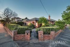  509 Camberwell Rd, Camberwell VIC 3124 Occupying the corner of Orrong Crescent and Camberwell Road in the desired Golf Links Estate, this charming solid brick home resides on approximately 445 square metres of premium land and is surrounded by established and manicured gardens, in this most convenient location.  An extensive renovation has provided a lifestyle of class and easy living, inside and out.  Delightful alcove entry and hallway lead into two double bedrooms, both with built in robes, formal lounge room and separate dining room which allows for relaxed living and formal entertaining. Renovated kitchen is complete with SMEG gas cooktop and oven, stone benchtops, dishwasher and an abundance of cupboard space with separate laundry at the rear. Outdoor decked entertainment area and low maintenance yards create a salubrious setting with extreme privacy provided by lush greenery - perfect for year-round enjoyment. Lock up garage includes access to rear.  Present features expected of the era include high ceilings, polished floorboards, leadlight windows and open fire place. Recent luxury additions include refrigerated cooling, heating and watering system to front yard  A simply sublime location of pure convenience within a short walk to Willison Park and Frog Hollow Reserve, tram and train station and only moments to Camberwell Junction shopping and cafes. Zoned for Camberwell High School. 