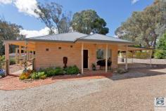  59 Back Creek Rd, Yackandandah VIC 3749 Sited on a delightful and secluded 1.5 acres, this property has lovely views across the valley, is less than 2kms from the township of Yackandandah and offers the perfect combination of lifestyle and town living. Built in 2011 by award winning Sapphire Sky Homes, this quality built home offers contemporary country living at it’s best. Inside you will be greeted by an open, light filled kitchen, dining and living space, with lovely black butt flooring, overlooking the established garden and property surrounds. Adjacent the main living space is a second living room /study or possibly third bedroom. With double glazed, windows and doors, a freestanding wood heater, ceiling fan and a reverse cycle split system, temperature control will never be a problem. And the 1.5kw solar system will surely assist with the energy bills. There are two large bedrooms with the master housing built in robes and lovely french doors opening out onto the covered veranda. The bathroom is spacious with a bath and separate shower. There is a small hand basin outside the bathroom which is very convenient for when the bathroom is occupied. Stepping outside you will find the land well cared for and fully fenced. The land could lend itself to a variety of uses, but presently provides refuge for a couple of sheep and an array of local birdlife. There is a double carport beside the home and a large 2 bay garage with a separate storage shed providing ample storage or a great workshop/studio space, plus a wood shed. Don’t hesitate, arrange your inspection today!!! 