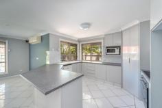  7 Corringle Cl, Helensvale QLD 4212 $599,000 Located in The Shores Helensvale - Backs onto Coombabah Lake  * Freshly painted. Tranquil colour scheme throughout * Super-spacious open plan family living/entertaining area * Light, bright kitchen with good storage and walk-in pantry * Long built-in bar with sliders to adjoining games areas * Spacious dining & family living. Air con. Surround sound * Games room opening to fenced pool & wrap around patios * Large master with mood lighting, ensuite & walk-in robes * Plus 3 further bedrooms 1 with air con. All with remote fans * Spacious study or 5th bedroom if required. Linen press x 2 * Double garage with windows - ideal extension potential * Carport with shade sail cover. Low maintenance gardens * Roller shutters providing privacy & security throughout  * LED low energy lighting, solar hot water & solar electricity * Rear shed & side concrete pad with lock for boat/caravan * Close to schools, public transport & community amenities Built by our vendors some twenty-five years ago, this spacious well designed home was in the throes of renovation when health issues caused changes in their plans, offering its new owners the opportunity to finish it off with their own personal style.  Recently painted, the tranquil colour scheme flows throughout, seamlessly linking one room with the next, leading to the wrap around indoor and outdoor living areas and kitchen with good storage and a walk-in pantry. This is a fabulous family area and an excellent venue for entertaining which will benefit further from a touch of flair by its new owners. Here a large built-in bar, spills through sliding doors into a screen-walled games room which opens to the fully fenced pool with shade sail on one side and a long wide patio to the rear. This area is also accessed from the lounge room where air conditioning keeps the whole area comfortable.  The home is gifted throughout with a plethora of electrical conveniences, - an amazing number power points, USB connections, TV points in every room and remotes for the fans. And in the living area, surround sound with five speakers keeps the party going. Another most important addition to this home was the $26,000 installation of roller shutters in all but one room, assuring absolute privacy and security as required.  The master bedroom is light and spacious with dramatic "bedhead" feature wall, air conditioning, fan and tranquil individually controlled mood lighting. The ensuite has dual vanity and offers the luxury of both soothing rain head and invigorating body jet showers. Adjoining this, the walk-in wardrobe is large and well-appointed. There are three additional bedrooms, one with air conditioning and all with fans. There's also a study (or fifth bedroom if required). The family bathroom is cleverly comprised of separate toilet and vanity areas and separate spa bath and shower, - an ideal set-up for the busy family. LED lighting throughout saves on power (and dollars) and there's both solar water heating and solar electricity. Storage is generous, both indoors and out, including a rear shed and side concrete pad with built-in lock - ideal for the boat or caravan. The large double garage has never housed a car, its current owners preferring to use it as a huge rumpus area for the kids. There are two windows here making it an easy addition to the house if required. In front of this is a carport with shade sail and there's a grassy area for the kids amongst low maintenance gardens. This is a spacious well-positioned family home and an excellent entertainer with central interactive living and recreation areas and plenty of outdoor space for fun in the sun or just stretching out on the patio with a good book. It's now just waiting for its new owners to add the extra finishing touches which will make it their very own. Early inspection is highly recommended. 