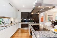  30 Azzurra Dr, Varsity Lakes QLD 4227 $1,545,000 Varsity Lakes finest home architecturally designed, this stunning 60 square home displays meticulous attention to detail. With an array of superior finishes, this home features 5 lavish bedrooms, each appointed like a master suite, fully fitted study upon entry, state of the art wireless theatre room, spacious living and brilliantly designed retreat areas, a high-tech security system that is simple to use plus many other extras.  This beautifully appointed home was built in 2009, presents as new and showcases... • 	 The ultimate chef's Miele kitchen, including Caesar stone bench tops, induction cooker, 3 ovens, 3 warmer drawers, integrated coffee machine and dishwasher, fridge/freezer and electrically height adjusted rangehood. • 	 3 ensuites, 1 two way bathroom, plus powder room • 	 Magnificent Theatre Room - wireless technology  • 	 Master bedroom suite; electric blinds, spa bath  • 	 Alfresco covered outdoor area with 5 burner BBQ • 	 Spectacular pool with gas heated spa  • 	 Solar hot water  • 	 Underground 5000 litre water tank • 	 Vacuum system & Ducted air conditioning FEATURES Air Conditioning  Pool 