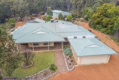  360 Summit Road, Mundaring, WA 6073 $719,000 Everything is in place to ensure you make the most of life on this 1-acre property. A wonderful, large 4 bedroom, 2 bathroom home with open plan living, generous bedrooms, a spectacular high-gabled paved alfresco with views of lawn and formal gardens and a fabulous 3-phase powered workshop. 4 bedrooms 2 bathrooms 1996-built brick and iron Vast open kitchen, living Large sunken loungeroom Sunny, airy studio / study Gorgeous jarrah benchtops Spectacular alfresco living Scheme, tank, bore water 1-acre, 3 phase workshop Minutes from Mundaring Generosity – room to move, play, grow, learn and work – infuses this home. Ideally placed, in every way, moments from the Mundaring Village, within easy reach of transport links, a choice of schools and arterial roads, this elegant 4 bedroom, 2 bathroom home, sits in a landscaped garden with a backdrop of gorgeous native vegetation and is sure to suit your family now and into the future. A circular drive surrounds a planting of citrus, herbs and an ornamental pear tree to create a striking first encounter. The home sits elegantly at the centre of the property – back from the road and elevated. An enclosed carport with roller door is arranged to one side of the home. A stain-glassed entry opens to a sunken lounge with views of rose bushes and the native landscape. A wonderfully restful space, generous proportions and plush carpets, perfect space for quite evenings at home or formal entertaining. Step up from the lounge room to the bright studio space. With French doors to the northern verandah and windows to the west, this room is an ideal workspace for artists and crafters. The spacious master suite, features a walk in robe, patio access, and a big, bright ensuite with a storage alcove. An impressive open plan kitchen / family room is incredibly comfortable and inviting thanks to warm-toned slate floors and gorgeous solid jarrah bench tops. A slow combustion fire, ceiling fan and high ceilings reinforce the feeling that this is a space designed to be the centre of family life. The kitchen contains a free standing 900mm Emilia oven, dishwasher, walk-in pantry and ample storage. The wide bench top forms a long breakfast bar and large windows wrap the corner of the room to deliver views of the gorgeous surrounds. Along the eastern side of the home is an impressive 9.2m x 6m paved, alfresco terrace. Covered by a high-gabled roof, the views of the garden, lawn and curved sandstone walls produce a restful and beguiling outdoor living area. The open plan family room leads to the junior wing, which includes two large bedrooms with built-in wardrobes, that offer views to the alfresco terrace and a third bedroom or study room. A large family bathroom with bathtub, separate shower and vanity is arranged with a separate W.C adjoining the walk-through laundry. Follow the lawn, past the wisteria and along the sandstone garden walls to reach the large, shed with 3-phase power. Vehicle access and a turning circle make for a practical workshop, double sliding doors, a side entrance and a bathroom with separate septic system ensure this approximately 15 m x 8 m space is adaptable to many uses. Beyond the property’s rear boundary is a wildlife corridor and bridle trail. A perfect balance of garden, bushland views and outdoor living, the landscaped gardens host established fruit trees, ornamental blossom trees and rose bushes. Set against a background of native vegetation, the effect is enchanting and wonderfully Australian. Maintaining the garden is made easier through the use of a reticulated bore and 43K litre tank. Generous, bold, yet unpretentious, the spacious home offers stylish living. Solid family-ready fixtures and high end finishes give a sense of enduring quality. Solar panels, established gardens, ducted evaporative cooling, bore water and proximity to Mundaring Village support a sustainable lifestyle for years to come. 