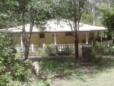  LOT 41 ENID COURT  BLACKBUTT North QLD 4306 $240,000 Welcome to Gatana,- Meaning Spanish lady, this unique Octagonal home is set on 4.04 hectares of amazing gardens and bush-land. Featuring 3 bedrooms with built in robe's this property is truly set out to complement the shape of the house. Through the front entrance you step into the main living area, equipped with an open fireplace for those cold winter nights, from there you follow on through to the dining area where the remaining rooms run off the central gathering area. The kitchen features an old wood stove that runs hot water from it and the house is surrounded by an undercover porch area with beautiful concrete balustrades that run the whole way around the house.  Off the beautiful shady porch you then step down into the undercover entertainment area, big enough to hold a small function. The area and its features complements the property and its surrounds. The gardens are a magical playground filled with garden paths and features at every turn, The Taromeo summer creek runs through the property creating the peaceful tranquility to get lost in as you walk around. The property is features a three bay parking area, chook house, storage shed, and an outside feature shed that would remind you of Holland. Alas, this property has been run down in recent years and needs TLC to get it back up to the beauty it is. But it has the potential for anything from a B&B, wedding venue or just simply make this your special home.  Offers Over $240,000 Gatana is just waiting for you to explore. 