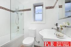  29 Edgbaston Rd Beverly Hills NSW 2209 $750K to $800K Close to station. 5 mins walk Ideally set opposite Edgbaston Reserve, this invitingly styled and tastefully updated period semi promises peace, privacy and light filled living space in abundance. With perfect proportions for family living and relaxed indoor /outdoor entertaining. 300m stroll to trains, shops, cinema and a variety of restaurants. Expansive open plan living with lounge area 4.8m x 4.3m and dining 3.4m x 4.1m (with skylight) extending fluidly through sliding glass doors to outside. Large level block with lush lawns and alfresco courtyard. Immaculately presented in contemporary neutral tones, ornate cornices, picture rails, recessed feature wall. Stylish kitchen equipped with stainless steel appliances- gas stove, dishwasher & pantry. Two oversized bedrooms PLLUS external bedroom/office/rumpus room (with air con). Internal laundry with separate toilet and 2nd shower. Renovated bathroom. Plentiful storage, timber flooring, and air conditioning. Double off-street parking. Close to schools, M5, Roselands Centro and short drive to Hurstville. 