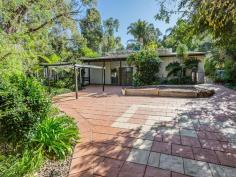  11 Valley View Road Roleystone WA 6111 $599,000 Summer is Coming Super pool oasis and totally private. This is your opportunity to secure a truly stunning multi level character home completely secluded and private, yet in the central village of Roleystone. This home is HUGE, with so many different living spaces. The western wing has a large lounge with 5 meter plus ceilings and incorporates a separate study (or even a 5th bedroom) and a super mezzanine floor to create your own art space or work area. The central area and the heart of the home has the very generous kitchen and informal dining. Sleek black cupboards, dishwasher and a walk in pantry you will love. Go down a few steps and you are in the spacious family room, also with super high ceilings. It all just seems so liberating. Set very separately to the rear of the home is an extra large games room. This design would lend itself to developing a personal space for older children or visitors. 4 bedrooms 2 bathrooms and a study (or 5th bedroom) and massive amounts of living all wrapping around a central courtyard/atrium. This space is really big ( around 30+ SQM or 5.5m x 6m) This allows so much light to the home. THE POOL! Wow…. This is the place to be and be seen. It is super lush and super private and adjacent is the perfect undercover patio (also built with style) There is so much more here. Viewing deck to take in the view, lockup garage, air conditioning, wood heater and gas points, auto reticulation, intercom beautiful ponds and PV solar on the roof to keep the power bills down. Lastly, but very importantly, this block has plenty of space for your boat or caravan or a good space for the workshop you desire. 
