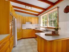  59 Cove Boulevard North Arm Cove NSW 2324 $565,000 - $620,000 Wake up to the sound of birdsong and take a short stroll to the water’s edge from this charming western red cedar cottage, perfectly located in the peaceful seaside hamlet of North Arm Cove. Surrounded by natural bushland and just minutes from the coast, the fully furnished four bedroom home offers a versatile range of lifestyle options, whether you’re looking for a weekend escape far from the hustle and bustle or seeking a more permanent sea-change amongst a tight-knit coastal community. Built in 2001 using western red cedar cladding and cypress pine piers, the tri-level home combines storybook charm with a more contemporary interior, featuring an appealing mix of natural textures and neutral tones. Exposed timber beams provide a warm contrast to the crisp white raked ceilings, enhancing the feeling of light and space throughout, while gleaming Tasmanian oak cabinetry gives the kitchen a traditional cottage ambience. The home features four bedrooms, with the master suite on the upper level of the house providing the perfect parents’ retreat. Facing the front of the property, it offers filtered water views that can be enjoyed from its own private east-facing deck, which is the perfect place to sit and enjoy an early morning coffee while watching the sun rise. A huge three-door built-in wardrobe and ensuite-style access to the adjoining bathroom add to its appeal, while further down the hall another generously-proportioned bedroom includes a walk-in wardrobe and views of the backyard. Two additional good-sized bedrooms are located on the lower level of the home, with a second bathroom, large walk-in storage cupboard and compact yet practical laundry. Both bathrooms have been beautifully styled with soft, neutral tones and timber accents, with a vintage style freestanding claw foot bath and gooseneck mixer tap the focal point of the main bathroom. The home’s expansive living areas are all located on the middle level, with fabulous indoor-outdoor connections to a covered L-shaped verandah at the front and large open timber deck at the rear. Sliding door access to the verandah, a high dormer window and soaring raked ceiling ensure the lounge room is a lovely, light-filled space, while cypress pine flooring and a wood-burning fireplace in one corner give it a cosy, comfortable feel. The timber flooring flows through to the adjoining dining room and open plan kitchen, which both look out over the rear deck to the lush, green landscape beyond. A peaceful and private home that makes the most of its elevated setting to capture the nearby water views, the property is ideally located just a short walk from the local community hall and tennis courts, which are a hub for local events, a social tennis competition and yoga sessions. Access to North Arm Cove itself is also within walking distance, with the picturesque Casuarina Park around 800m north of the property. A wonderful place for children to play or families to picnic, the park features barbecues and tables as well as kayak and dinghy storage racks and direct access to the sheltered waters of the bay, which are perfect for a refreshing paddle, water sports and fishing. The twin seaside towns of Hawks Nest and Tea Gardens are just a 15-minute drive, providing all your essentials, while 20 minutes to Newcastle Airport will put a host of domestic destinations including Melbourne, Brisbane and Adelaide a direct flight away. The major centres of Newcastle and Maitland can be reached in around 50 minutes, while the heart of Sydney is an easy two-and-a-half hour 