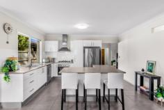  1 KOORINGAL STREET TINGALPA QLD 4173 $625,000 Wonderfully located in the high demand suburb of Tingalpa and within close proximity to Moreton Bay, schools both public and private, Wynnum Plaza and Aldi, Cafes, restaurants and parks for the kids. This stylish, lowset brick and tile home is only 9 years old. Boasting four very large bedrooms all with built in robes, ceiling fans, roller blinds and Air conditioning. The master bedroom includes private walk in robe with built in cabinetry and attached ensuite. A double door hall way cupboard allow for extra storage which is often missing in new homes. The modern, open plan kitchen and dining flows out to the delightful, undercover entertaining area. The kitchen is well appointed with a unique L shape island bench, stainless steel appliances, 5 burner gas cook top and electric oven. There is ample cupboard space as well as breakfast bench for the kids. The bathroom has a separate shower and bathtub perfect for young families and all fittings are stainless steel. The outdoor dining area is perfect for the summer BBQ’s and is set amongst tranquil bushland so no rear neighbours. The yard is fully fenced for the family pet. Loaded with essentials, the home comes with quality fixtures and fitting, easy care tiles in all the living spaces, double lock up garage with extra storage space, ceiling fans and split system air conditioning, a 5000lt rainwater tank and electronic keyless entry. Be quick and make this house your new home today. 
