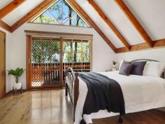  59 Cove Boulevard North Arm Cove NSW 2324 $565,000 - $620,000 Wake up to the sound of birdsong and take a short stroll to the water’s edge from this charming western red cedar cottage, perfectly located in the peaceful seaside hamlet of North Arm Cove. Surrounded by natural bushland and just minutes from the coast, the fully furnished four bedroom home offers a versatile range of lifestyle options, whether you’re looking for a weekend escape far from the hustle and bustle or seeking a more permanent sea-change amongst a tight-knit coastal community. Built in 2001 using western red cedar cladding and cypress pine piers, the tri-level home combines storybook charm with a more contemporary interior, featuring an appealing mix of natural textures and neutral tones. Exposed timber beams provide a warm contrast to the crisp white raked ceilings, enhancing the feeling of light and space throughout, while gleaming Tasmanian oak cabinetry gives the kitchen a traditional cottage ambience. The home features four bedrooms, with the master suite on the upper level of the house providing the perfect parents’ retreat. Facing the front of the property, it offers filtered water views that can be enjoyed from its own private east-facing deck, which is the perfect place to sit and enjoy an early morning coffee while watching the sun rise. A huge three-door built-in wardrobe and ensuite-style access to the adjoining bathroom add to its appeal, while further down the hall another generously-proportioned bedroom includes a walk-in wardrobe and views of the backyard. Two additional good-sized bedrooms are located on the lower level of the home, with a second bathroom, large walk-in storage cupboard and compact yet practical laundry. Both bathrooms have been beautifully styled with soft, neutral tones and timber accents, with a vintage style freestanding claw foot bath and gooseneck mixer tap the focal point of the main bathroom. The home’s expansive living areas are all located on the middle level, with fabulous indoor-outdoor connections to a covered L-shaped verandah at the front and large open timber deck at the rear. Sliding door access to the verandah, a high dormer window and soaring raked ceiling ensure the lounge room is a lovely, light-filled space, while cypress pine flooring and a wood-burning fireplace in one corner give it a cosy, comfortable feel. The timber flooring flows through to the adjoining dining room and open plan kitchen, which both look out over the rear deck to the lush, green landscape beyond. A peaceful and private home that makes the most of its elevated setting to capture the nearby water views, the property is ideally located just a short walk from the local community hall and tennis courts, which are a hub for local events, a social tennis competition and yoga sessions. Access to North Arm Cove itself is also within walking distance, with the picturesque Casuarina Park around 800m north of the property. A wonderful place for children to play or families to picnic, the park features barbecues and tables as well as kayak and dinghy storage racks and direct access to the sheltered waters of the bay, which are perfect for a refreshing paddle, water sports and fishing. The twin seaside towns of Hawks Nest and Tea Gardens are just a 15-minute drive, providing all your essentials, while 20 minutes to Newcastle Airport will put a host of domestic destinations including Melbourne, Brisbane and Adelaide a direct flight away. The major centres of Newcastle and Maitland can be reached in around 50 minutes, while the heart of Sydney is an easy two-and-a-half hour commute. 
