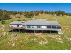  1568 GREAT NORTHERN HIGHWAY UPPER SWAN WA 6069 $1,760,000 A stunning 58 acre rural property just 45 minutes or approximately 33 kms from the Perth GPO. Nestled high up on the escarpment this custom built farmhouse has large open plan living areas and 2 expansive deck areas all taking in the uninterrupted views over the Swan coastal plains from Bullsbrook to the city. There are 5 double bedrooms, 2 bathrooms, an upstairs office and a separate activity/media area for the children. 4 bedrooms have bi robes and the master bedroom has a walk through dressing room to the ensuite with a spa bath. Extras include a 3 bay carport under the main roof, a farm size laundry, reverse cycle air conditioning, a slow combustion wood heater, solar power connection with 2 x 2.5 kilowatt inverters and mains water access. The farmhouse overlooks 5 fenced paddocks with a dam and windmill providing water to each paddock. There is also a 5,700 kilolitre water licence that remains as part of the sale of this property.  