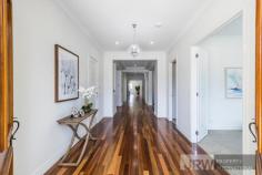  20 HEADINGLEY ROAD MOUNT WAVERLEY VIC 3149 Radiating refined elegance, this indulgent double storey residence blends its opulent scale with lavish fittings and quality craftsmanship to create a home like no other in the sought-after Mount Waverley Secondary Zone. Inspiring easy living, decedent double doors open to reveal a lengthy entrance hall that draws you past the study, formal lounge and private theatre room all adorned with comforting carpet. Graced by glamorous floorboards, the indulgent kitchen, meals and family room showcases waterfall stone benches, a window splashback, high-end cabinetry and appliances, a desired 2nd kitchen plus a convenient breakfast bench. Connecting to this space, entertainer's will appreciate the inclusion of a covered alfresco entertaining zone with outdoor kitchen set-up, while the low-maintenance backyard presents space for children to play.  Ensuring the family's every desire is met, the upper level comes with a wonderful retreat/living room and hosts four of the five bedrooms (all with walk-in-robes and individual ensuites), including the master with concealed robes, balcony and lavish ensuite, further complemented downstairs by a guest bedroom with walk-in-robe and ensuite, laundry and powder room. Highlighted by ducted heating, refrigerated air conditioning, alarm, high ceilings, gated driveway access plus a double garage with internal access. 
