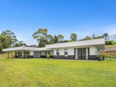  2-14 Acacia Court Beechmont QLD 4211 $870,000 In the heart of Beechmont surrounded by the lush vegetation of the Scenic Rim you will find this contemporary 3.18 acre, one of its kind property.  With a blend of sophistication and elegance this property offers country living with a city feel.  Built to the highest standard, the main residence is architecturally designed with 4 spacious bedrooms, 2 bathrooms and a kitchen any budding cook would love. Also on offer is a huge garage built with the same design as the house, which will fit up to 6 cars. Attached to this is a fully self contained one bedroom dwelling also designed to compliment the features and design of the main house. Other features include: Electric front gates  Fully fenced on all boundaries  Bore with pump up to 2 large in-ground water tanks  Air-conditioners throughout  Marble tiles in bathrooms  Gas cooking  Circular gravel driveway  10m x 8.4m carport / undercover entertaining area  Large windows overlooking views  Gas fireplace  Large laundry 