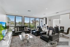  5 BELSAY CHASE CHIRNSIDE PARK VIC 3116 $600,000 - $660,000 Set apart from the rest, this newly developed architecturally designed sanctuary is a spectacular example of contemporary suburban living.  Over two levels and highlighted by a spacious lounge and dining zone, flexible upstairs retreat, and terrific low maintenance Zen courtyard. This picturesque and peaceful property is at the gateway to the Yarra Valley and only a stone's throw from wonderful Chirnside Park attractions including schools such as Oxley College, parks and Chirnside Park Shopping Village which is within only walking distance! Awash in superb natural light and owning superior fittings and fixtures throughout, this generous family haven exudes warmth. Showcasing an enormous rear living zone, with a meals area enjoying exquisite pendant lighting, and access to the easy-care alfresco area through the breezy double doors. The vogue kitchen has shimmering black stone surfaces, an island bench and quality stainless steel gas appliances, while the additional upper level retreat is brilliantly flexible.  The master suite features full-length windows allowing an abundance of natural light as well as a walk-in robe and immaculate ensuite, captivating with a deep freestanding bath tub. The two other bedrooms own robes and a shared balcony and neighbour the pristine, fully tiled central bathroom with a wall-to-wall shower.  Also enjoying a sleek powder room, under stairs storage, ducted heating, evaporative cooling, tinted windows, split system units, LED down lights, low maintenance tiling throughout bottom level, security doors at front and rear, a laundry with access to the remote garage. 