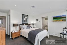  5 BELSAY CHASE CHIRNSIDE PARK VIC 3116 $600,000 - $660,000 Set apart from the rest, this newly developed architecturally designed sanctuary is a spectacular example of contemporary suburban living.  Over two levels and highlighted by a spacious lounge and dining zone, flexible upstairs retreat, and terrific low maintenance Zen courtyard. This picturesque and peaceful property is at the gateway to the Yarra Valley and only a stone's throw from wonderful Chirnside Park attractions including schools such as Oxley College, parks and Chirnside Park Shopping Village which is within only walking distance! Awash in superb natural light and owning superior fittings and fixtures throughout, this generous family haven exudes warmth. Showcasing an enormous rear living zone, with a meals area enjoying exquisite pendant lighting, and access to the easy-care alfresco area through the breezy double doors. The vogue kitchen has shimmering black stone surfaces, an island bench and quality stainless steel gas appliances, while the additional upper level retreat is brilliantly flexible.  The master suite features full-length windows allowing an abundance of natural light as well as a walk-in robe and immaculate ensuite, captivating with a deep freestanding bath tub. The two other bedrooms own robes and a shared balcony and neighbour the pristine, fully tiled central bathroom with a wall-to-wall shower.  Also enjoying a sleek powder room, under stairs storage, ducted heating, evaporative cooling, tinted windows, split system units, LED down lights, low maintenance tiling throughout bottom level, security doors at front and rear, a laundry with access to the remote garage. 