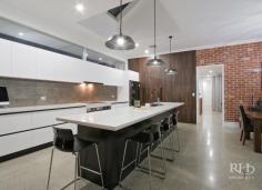  5C KISHORN ROAD Applecross WA 6153 $1,999,000 Register your interest today in this amazing home. Beautifully presented and as-new. This modern home makes no compromises with high-end designer interiors meeting elegant alfresco living on a superbly manicured 704sqm green-titled block with in-ground pool. The spacious single-level floor plan also offers plenty of space, for family living, and you’ll love this convenient family-friendly location that’s opposite Applecross Primary School parklands, and just moments to Ardross Street cafes and shops. -- Living/dining area with polished concrete floor, modern chandelier and stylish feature wall  -- High-end designer kitchen with stone bench tops, sleek cabinetry and premium appliances  -- Generous home office or additional living space off the main living/dining area  -- Carpeted, king-sized master bedroom with large walk-in robe through to luxury ensuite  -- Three large additional bedrooms plus an extra sitting room provides even more living space  -- Stunning main bathroom with twin vanity, bath, shower and private alfresco terrace  -- Large integrated entertainer’s patio features high-end alfresco kitchenette with fridge  -- Secure, manicured grounds plus a sparkling in-ground pool with frameless glass fence  -- Well-equipped internal laundry with plentiful cabinetry and powder room with vanity  -- Gated front access to private front yard with large lock-up garage and solar power system Secure gate entry ensures your privacy as you enter into the fully fenced front yard that features manicured lawns and a sparkling in-ground pool with frameless glass fence. Continue inside where the stylish open-plan living/dining area will impress with premium on-trend styling including polished concrete flooring, a raw brick feature wall, distinctive contemporary light fittings, an over-sized Plantation-style ceiling fan and a stunning atrium-style ceiling recess to the living area. The immaculate high-end kitchen will fulfil every home chef’s wildest dreams, and entertaining is a real treat on the large integrated patio with alfresco kitchenette. The king-sized master bedroom is another standout feature of the home with a large walk-in robe and luxury designer ensuite that features a striking freestanding bath, twin vanities, floor-to-ceiling tiles and a large open rain-head shower behind a stunning raw brick partition. An additional sitting room and a generous home office provide even more living space, and the large second, third and fourth bedrooms – all with built-in robes – share the quality family-sized main bathroom to complete this impressive package. For more info, call Frank Sanchez on 0419 367 999 or Mike Quirici on 0402 085 533. DISCLAIMER: Whilst every care has been taken with the preparation of the particulars contained in the information supplied, believed to be correct, neither the Agent nor the client nor servants of both, guarantee their accuracy. Interested persons are advised to make their own enquiries and satisfy themselves in all respects. The particulars contained are not intended to form part of any contract. 