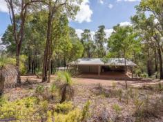  15 Milligan Road Parkerville WA 6081 $699,000 Come home to the beauty of nature with this 3 bedroom, 2 bathroom brick and iron home. The 1983-built Kentucky Homes residence is in perfect harmony with its natural 5-acre landscape and offers fantastic outdoor living and entertaining on the wide, elevated verandah. A floorplan that delivers formal and informal living gives you the flexibility to utilise spaces in a way that suits your lifestyle and the seasons. 3 bedrooms 2 bathrooms 1983-built brick and iron High pine-lined ceilings Open family and kitchen Formal lounge and dining Junior wing with activity Elevated, shaded verandah 4-car carport + workshop Natural 5-acre cul-de-sac Perfection in Parkerville Homes that have only ever known one owner are invariably imbued with love and an atmosphere of instant welcome – a sense of ease and contentment envelopes this 1983-built brick and iron home. From the private cul-de-sac address and the soothing natural setting to the warm, well-designed home with exposed brick and high ceilings, this property is a lesson in living lightly in the Hills. A wrap around verandah paved with bricks draws you to an expansive alfresco entertaining area and into the open plan family room, and kitchen arranged at the centre of the home. Exposed brick, a slow combustion fireplace and high, pine panelled ceilings deliver a cosy and airiness. A brick surround houses a slow combustion fireplace in the family room and an open fireplace in the formal dining and lounge room to create a central heat bank. Cork floors and pine cabinetry give the kitchen an organic style while electric hotplates, a wall oven and dishwasher fashion a user-friendly space with a large pantry. To one side of the central living area is the formal dining and lounge room. A ceiling fan and open fireplace ensure this space is ready for year-round entertaining while high ceilings and views of grass trees and eucalypts fashion a serene second living area. Arranged across the eastern face of the home is the main bedroom suite consisting of a large bedroom, walk-in robe, ensuite and private study. Reverse cycle air-conditioning and a ceiling fan manage climate control in this separate adult zone. A good-size study offers a private retreat that could be styled as a secluded library or spacious dressing room. A design that allows areas of the home to be closed off when not in use makes this home a great fit for young families, those with teens and empty nesters who like to have guests.  A separate junior wing at the western end of the home contains two junior bedrooms, a family bathroom and a large activity/studio room opening to the verandah. The large activity/studio is suited to various uses. Light-filled and looking out to the south, this space would make a terrific activity room, studio or crafting room. Extending out from the activity room is a wide alfresco entertaining area with a deep gabled roof extending low on the western edge. This elevated and paved space provides a beautiful outdoor dining area or a fabulous place to sit and absorb the beauty of your surroundings. Towards the front of the property are a large powered workshop, separate storage area and a 4-car carport. The home benefits from both scheme and bore water and has sprinklers fitted to the roof. Everything you imagine should be a part of Hills living is here: a private natural setting, a charming, comfortable home with a flexible floorplan and fabulous outdoor living just minutes from the bustling Mundaring Village. 