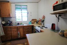  127 Wilmington St Ayr QLD 4807 $79,000 Don't miss this idea opportunity as this low set 1 bedder is perfect for those starting out in the market or looking for that good sized block to build or as a 'rental' which is it's current use and recieving $165 per week... WOW... Priced to please and on a fenced 1012m2 lush town block bragging only minutes away from the CBD, supermarkets and schools... Offering combined kitchen and dining with good sized living area and  one bedroom which is air conditioned... Front enclosed verandah which is also home to the bathroom amenities... Downstairs under the back lean to is the laundry... The yard is fenced and with a handy garden shed and dotted with fruit trees including mango, citrus and passionfruit. Bragging a tremendous amount of room for that colour bond shed and so much more... This one won't last long so hurry and call to arrange your inspection today! FEATURES Verandah Undercover outdoor area Fenced Close to school 