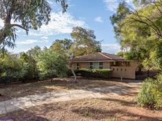  20 Innamincka Road Greenmount WA 6056 $319,000 Loved and cared for by the one owner for the last 48 years, this custom designed home, set on a big ¼-acre (1007sqm) block, boasts original elements and a functional floor plan to deliver a property with character and potential.  The comfortable brick and tile home features good sized bedrooms, a sunken lounge and a dining room with views across a patio to the big backyard. • Cherished 1 owner home • 2 bedrooms 1 bathroom • Spotless eat-in kitchen • Big sunken lounge room • Fabulous orig features • Good-sized bedrooms • Large family bathroom • Carport & garden shed • Mostly level 1007m blk • Cls to popular schools This cherished and happy 2 bedroom, 1 bathroom home has been maintained in immaculate condition by one owner. Original features bring charm and character, while a well-considered floorplan makes for comfortable, modern living. The ¼-acre lot, big backyard and super-convenient location – within easy reach of the services and amenities of town and the outdoor beauty of the Perth Hills – make for a home rich with possibilities and an attractive option for all buyers. A magnificent gum tree standing sentinel at the entry is your first hint of the generosity and welcome that imbues this property. A wide porch and tiled entry hall lead to a sunken loungeroom and dining area. A big picture window in the lounge area looks out to a green screen of an established garden. In the dining area, a sliding door opens to an elevated patio to create an indoor-outdoor entertaining area overlooking the expansive backyard. Reverse cycle air-conditioning and a northerly aspect bring year-round comfort to this flexible, open-plan living space with warm timber architraves and fresh, white walls. Adjoining the dining area is the original kitchen – impressive 70’s lino and the tiled splashback offer authentic style underlined by ample original cabinetry and a freestanding oven. A practical well-designed space, the kitchen is large enough to accommodate a breakfast table. Two good-sized bedrooms, the larger with a wall of built-in robes and a ceiling fan, share a large family bathroom with shower, Roman bath, vanity and W.C. The walk-through laundry opens to the paved carport on the home’s eastern side and an expansive backyard with a carob tree, pomegranate, frangipani and garden shed surrounded by a lawn and easy-care gardens filled with the sound of birdsong. This little gem is ready for new custodians and represents a fantastic framework on which to build your dreams. Its proximity to schools, services and amenities ensure its appeal now and into the future. Embrace the unmistakable charm of its 1970’s origins or take advantage of the ¼-acre lot and desirable foothills address to fashion your very own version of a happy home. 