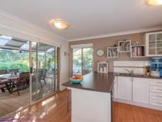  8 Painter Crescent Mundaring WA 6073 $549,000 Take the plunge and dive into life in the Hills in this 4 bedroom, 2 bathroom home built for indoor-outdoor living and set on a 2017 sqm lot. Boasting a sparkling decked pool, fantastic dining pavilion and superb alfresco entertaining area, this family home is tucked away on a leafy crescent, steps from Mundaring Primary School, an easy walk to Stoneville Road and minutes from the bustling Mundaring Village. This 1999-built brick and iron home offers the best of Hills living with privacy, convenience and green-hued serenity. 4 bedrooms 2 bathrooms 1999-built brick and iron Stylish modern kitchen Relaxed open-plan living Fabulous dining pavilion Big gabled alfresco ent. Sparkling decked pool ½-acre fenced backyard Walk Mundaring Village Life in the Hills is a life filled with the beauty of the great outdoors – this 4 bedroom, 2 bathroom has been created to embrace that beauty. The modern and stylish home offers open-plan living and a fabulous all-seasons dining pavilion. The ½-acre level block sits on a hidden Mundaring crescent, minutes from the local primary school and with walking tracks to bus stops on Stoneville Road and the Mundaring Village. Surrounded by an atmosphere of privacy and serenity, the front door of this brick and iron home opens to an open-plan family/dining/kitchen. Warm toned-floors, fresh, white walls and a slow combustion fire offer an instant welcome, a welcome that is extended with style thanks to a fabulous dining pavilion adjoining the living area. Screened doors on three sides open this flexible and practical room to a small patio at the front of the home and the expansive alfresco entertaining area looking across the decked pool and lightly-treed backyard. Whether you are entertaining friends or enjoying the alfresco life with family, the well-designed kitchen puts everything in place to make for easy meal prep. An electric hob and oven, dishwasher and corner pantry are surrounded by hi-gloss white cabinetry and a benchtop and breakfast bar. The expansive alfresco entertaining area provides additional space for preparing meals with a fitted bench and ready-made barbeque area. Melding seamlessly with the dining pavilion and open plan living area, this covered space sits surrounded by lawn and gardens and overlooks the sparkling decked pool. With room for a large table and a separate seating area, paths lead to raised vegetable beds – fresh herbs to hand when you need them – and out to the fully-fenced backyard and garden shed. Clearly built for enjoying the outdoors, the home also provides stylish and comfortable interior spaces. The main bedroom suite offers a serene retreat with an ensuite and large mirrored wardrobe. A ceiling fan and soft carpets extend the pampering atmosphere while garden views fill the room with a gentle, green-hued light. The 3 junior bedrooms – carpeted and fitted with wardrobe recesses – also enjoy views of the garden. A family bathroom, with shower, tub and vanity, is arranged beside the walk-through laundry with separate W.C. Discover life in the Hills at its best in this beautifully present, perfectly placed home. Dive into a sea of green with great indoor-outdoor living, a fully-fenced backyard and sparkling salt water pool. Hidden yet centrally located, this property balances privacy and convenience with easy access to schools, public transport and the bustling village of Mundaring. 