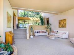  15C Gilwinga Drive Bayview NSW 2104 $5,900,000 - $6,400,000 Hidden in a private bushland setting with a magical sense of serenity, this palatial family home commands sweeping views across the waters of Mccarrs Creek and is one of the largest and most exclusive estates on the Northern Beaches. There are endless possibilities for this including reinstating the tennis court or considering subdivisions. Every dimension of the architect designed layout is generous Grand entrance with expansive and versatile living spaces Wraparound entertainment balcony and alfresco terraces Sauna, billiards room and an idyllic garden oasis with pool Enormous master bedroom, jet spa ensuite and walk-in robe Enormous master bedroom, jet spa ensuite and walk-in robe Solid construction ready for contemporary refurbishment Reinstate the original subdivision of 15d Gilwinga Drive (STCA) Automated garage, tranquil level grounds and lush gardens A rare 2 hectare offering, available for the first time in 31 years 