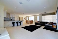  21 Wrasse Corner Yanchep WA 6035 $669,000 - $689,000 Be captivated from the moment you arrive – this prestigious beachside residence is nothing short of impressive with generous open plan design and versatile living spaces, this family home is a dream by the sea. Totally energy efficient with 6.4kw solar electricity, just a stones throw to sparkling beaches, and only minutes from Yanchep Central Shopping Centre, schools, medical facilities, cafes, Yanchep National Park, Golf Course and more, you won’t find better value on the coast! Features of this immaculate home include: + Stunning street appeal with fully enclosed courtyard and decked outdoor lounge area. + Vast open plan kitchen, dining and family areas – gourmet kitchen equipped with stone tops, walk-in pantry, plentiful cupboard and bench space and quality appliances + Step outdoors to an enticing entertainers retreat with built-in BBQ & pizza oven under a large alfresco, sleek split level decking area with heated plunge spa pool and under cover built in bar + King sized master bedroom with spacious double vanity ensuite plus spa bath & walk in robe + 3 queen sized bedrooms with double robes + Semi-ensuite & powder room to bed 1 and a stylish family bathroom for beds 3 & 4 + Upstairs features an expansive living area or 5th bedroom with ample storage, stylish kitchenette, and an inviting balcony area with awesome ocean views VALUABLE EXTRAS: 6.4 kw solar electricity, ducted reverse cycle air-con, downlighting throughout, quality window and floor treatments, double remote garage, low-maintenance gardens to front, electric shutter door to alfresco, ample storage space, laundry and so much more… 