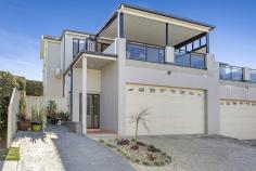  1/29 OLD SADDLEBACK ROAD KIAMA NSW 2533 $740,000 - $790,000  This spacious three bedroom Torrens Title/Strata Free townhouse is located in a small complex and enjoys ocean views from its large indoor/outdoor terrace. As you walk through you will fall in love with the spacious open plan living dining area with tiled floors and beautifully kitchen with stone benchtops flowing out to your totally private synthetic grassed courtyard. There is a second living area on the first floor which opens onto the huge covered indoor/outdoor terrace complete with sweeping views over Kiama and to the ocean and with bifold windows and shutters which ensures this space can be enjoyed all year round. There are three double size bedrooms ,the main bedroom features a walk-in robe and ensuite and opens out to the outdoor terrace. Two more generous bedrooms with built-ins and main bathroom featuring a beautiful spa bath. With security and peace of mind this property also has a large two car garage with automatic door and internal access. This gorgeous home is made feel very private behind the well established landscaped gardens, hedges and dry-stone wall. Quality features include; • 2 x Split System Air Conditioners • Gas heating • Dishwasher • Stainless steel appliances • Spa Bath • Bifold windows and shutters to the Covered Outdoor terrace • Private courtyard and established gardens. • Ceiling Fans 