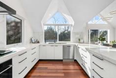 54 Seaview Road  Frankston South VIC 3199 $1,300,000 - $1,430,000 Inspired by Hamptons-style elegance and awash with natural light, this four-bedroom architect-designed residence on two thirds of an acre (approx.) offers stunning distinction and luxurious space with soaring cathedral ceilings, triangular clerestory windows, rich timber floors and lovely bay glimpses. The striking multi-level design showcases an inviting entrance hall that branches off to three different living zones including a lounge room with an open fireplace opening to the covered alfresco area and a large family room that opens to its own balcony. A contemporary showpiece that is both stylish and functional, the modernised kitchen features stone benchtops, a walk-in pantry, matte black tapware/hardware, Asko appliances and a zip tap, while designated formal and informal dining areas are equally inviting. Separately-zoned for privacy, the master suite is a haven of indulgence with a walk-in-robe and designer ensuite with double vanity, while two further bedrooms on the lower level share a family bathroom with deep freestanding soaker tub and their own lounge or home office. A charming loft provides a delightful bonus living space that can be used as a fourth bedroom or children's retreat. Standing proudly among landscaped gardens, a secure yard, CCTV, double garage and carport, this property is set within the coveted Frankston High School zone and enjoys a sought-after location just steps from Derinya Primary School and bus stops and moments from the beach and Frankston's shopping precinct. Should you require further information, please call Ash Weston on 0439 101 677 or Brooke Wegener on 0448 382 643 anytime. Please note that photo ID is required at all inspections. 