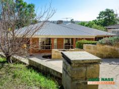 38 Amethyst Crescent Mount Richon WA 6112 $379,000-$389,000 This is not just a house, IT’S A HOME. Oozing, warmth, character and charm, this delightful four bedroom two bathroom family home will tick a lot of boxes on your shopping list. This is easily the best value home in Mount Richon, don’t take my word for it see for yourself. Offering a fabulous hills lifestyle, a sought after location and fabulous valley views, why would you want to bring your family up anywhere else? Although this lovely home sits on a large 709m2 block and is family orientated, it is also very low maintenance, which means it would suit downsizers as well. The front yard has a large decked area with poured limestone, and the backyard has a massive decked/ poured limestone patio/entertaining area which utilises half of the backyard. The home itself is well laid out with a free flowing floor plan. There is a separate entry with the master suite adjacent to the right and the fabulous sunken formal lounge/dining to your left. The master suite is a good size with split system heating and cooling and the ensuite has been recently updated. The formal lounge is gorgeous, an ideal retreat for Mum and Dad and a lovely room for dinner parties to entertaining friends. There are polished french doors that give direct access the family room from here. The kitchen is centrally located and the hub of the home. it is large in size with ample cupboard space and a large work bench/preparation area., it overlooks the casual meals area. All the guest bedrooms, the second bathroom, WC and laundry are found at the rear of the property accessed from the spacious games/rumpus room. All bedrooms have built in robes, the bathroom is large and has a separate bath and shower, ideal for the little people. This area can be shut off from the main living areas, making it the ultimate play area. A false wall has been installed in the rumpus room to segregate an area that can be used as a study. It can be easily removed if not required. Last but not least, the vast backyard patio/entertaining area is to die for, with timber decking, a raised seating area, grassed area for the kids, all overlooking majestic valley views, what more could you want. To view this super home call for a private appointment or look out for the advertised home opens. 