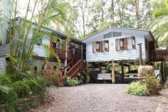  MALENY QLD 4552 $747,000 On a private and secluded 6,500 square metre block, only minutes from Maleny's main street, this delightful six bedroom timber pole home is filled with interesting features. Main living areas open to wide timber decks where you can relax and enjoy the native bird life and serenity of the beautiful bushland setting and the view over adjoining grassland. The heart of the home, a country style kitchen, features gas and electric cooking, ample bench space, dishwasher and a large pantry. There are three bathrooms, 9' ceilings, a slow combustion log fire and polished hardwood flooring. Downstairs has tiled flooring, air conditioning, lounge and a study plus two workshops. The home has a warm and inviting feel and would suit anyone looking for a home with style and character; it would also be ideal as a bed and breakfast venue. Inspection is a must to appreciate the charm and value of this delightful home and garden walkways. 