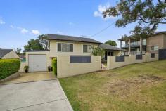  1A Bayview Street Warners Bay NSW 2282 $720,000-$770,000 Light-filled and recently revamped, this modern family home offers versatility and easy living in a central location. An easy stroll to lakeside walking trails, an array of eateries along The Esplanade and the shopping centre. Set over two air conditioned levels, the ground floor comprises a tiled entry foyer which leads into the generous multi-purpose room, and includes a study nook and internal laundry with second bathroom. Upstairs is graced by LED downlights, with polished timber floors throughout the living spaces and fresh carpet through the bedrooms. A bright family lounge room opens to the the covered verandah to overlook the front yard. Adjacent to the lounge is the open dining room and stylish kitchen appointed with stainless steel appliances. The four double bedrooms all offer built-in robes and ceiling fans, and share the modern bathroom complimented by floor to ceiling tiles, chrome fixtures, double floating vanity, glass framed shower and toilet. Outside, low-maintenance gardens and fenced lawn space with additional garden shed storage and a single lock-up garage make this the perfect home for the modern family. Take the tour to experience what this home has to offer! KEY FEATURES: Air Conditioning Built-In Wardrobes Close to Schools Close to Shops Close to Transport Garden... 