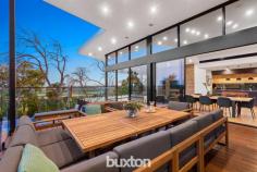  5A Merilyn Way Frankston South VIC 3199 $2,300,000-$2,530,000 Architecturally designed to optimise expansive views to Westernport, this breathtaking 5-bedroom residence effortlessly incorporates family functionality with a stunning use of natural elements. Rammed earth & Spotted Gum are standout features - combined with soaring ceilings and vast amounts of glass, this incredible family showstopper will quite literally take your breath away. Privately positioned at the end of a long driveway on approx. 2684sqm, auto gates open to reveal a truly spectacular home - step inside, and its interiors will instantly surpass all expectations. From the entrance hall, the views are immediately evident – whether reclining in the awe-inspiring living/dining area with suspended fireplace, or preparing meals in the state-of-the-art Miele kitchen, the home’s elevated position above the Peninsula will always impress. An HIA-award-winning bathroom with decadent freestanding bath stars in the master retreat which also enjoys sweeping vistas of the region. A guest bedroom with ensuite is also located on this level whilst three more bedrooms, a lounge area and family bathroom are all separately zoned – perfect for kids or extended family members. With a host of luxury inclusions only a visit will uncover, among the highlights are jaw-dropping infinity edge pool, outdoor kitchen, automated blinds, ducted vac, zoned heating/cooling, home office, Sonos sound, wine cellar, comprehensive security, aquarium and double auto garage. The home also benefits from incredible amounts of storage throughout. In a peaceful low-traffic cul-de-sac – this really is a once in a lifetime opportunity. 