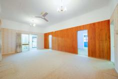  11 Birdwood Street North Ipswich QLD 4305 $299,000+ This home has been meticulously maintained, featuring high ceilings, plenty of living area, a huge amount of storage space and stunning gardens. Whether you are a first home buyer, renovator or investor - this property is truly something special; don't miss out, book your inspection today! - Massive main lounge room; air-conditioned with ceiling fan, carpet and extra-high ceilings - Huge kitchen with high ceilings and an enormous amount of preparation and storage space; ceiling fan, vinyl flooring and electric oven, large enough to serve as an eat-in kitchen if desired - Spacious formal dining/secondary living area; carpeted with raked ceiling - 3 bedrooms, 2 with ceiling fans, extra-high ceilings and additional dressing room/office spaces adjacent - Bathroom is neat and tidy and features a combined bath/shower with sliding glass screen; separate toilet - Front entry provides an additional living/office/play space; carpeted - Underneath the home is a vast concreted and enclosed storage/rumpus space with multiple sections; extremely neat and tidy with good lighting and ventilation, laundry located within the main area - Extra-wide double lockup garage with direct internal access both upstairs and downstairs - Built-in BBQ area adjacent to fully concreted driveway - Gorgeous landscaped gardens throughout the property; well established and maintained - 2 well-sized garden sheds plus greenhouse/aviary - Fully fenced property - Security screens throughout Area Details: • 	 Walking distance to public transport access • 	 2 minutes* to Ipswich North State School • 	 2 minutes* to St. Josephs Primary School • 	 4 minutes* to Riverlink Shopping Centre and Ipswich CBD • 	 6 minutes* to Ipswich Hospital • 	 8 minutes* to USQ Ipswich Campus • 	 Easy highway access for commuters.. 