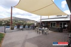  4 Heinecke Lane Tumbarumba NSW 2653  $590,000 Here's one that surely tickles the taste buds! Nested high on the hill with outstanding views over the township Eye pleasing from the outside - quality on the inside Welcoming entrance foyer Tiled living areas Kitchen with Tasmanian Black Wood cupboards and granite bench tops Natural light from the extended high set skylights Main bedroom with ensuite, all bedroom with built in's + ceiling fans Storage room + office space 3 bathrooms in total! Kitchen, dining & living + formal lounge room Reverse cycle + 2 wood fire places And that's just the inside ... Huge yard of 6739m2 (1.6 acres) Entertaining area overlooking the in-ground pool 5 garages in total (3 bay + 2 x single attached to the home) Double wood shed with slide top roof for easy access.. 