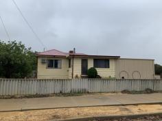  65 Fairbank St Ballidu WA 6606 $69,000 Are you looking to get out of the rat race & enjoy some fresh country air? Keep reading...  This 2 bedroom 1 bathroom fibro & colourbond home with a sleep-out sits on a 993sqm corner block in the cosy & quiet town of Ballidu.  Large front lounge room is carpeted with freestanding wood fire, provides plenty of space & has access to carport through side sliding door.  Dining room comes off the lounge room & has wall mounted air-conditioning.  Kitchen is basic with single stainless steel sink & gas cooking.  Both bedrooms are carpeted with the main room having ceiling fan, NBN connection point & a Foxtel point.  Bathroom is a combined shower/bath recess with freestanding vanity.  A carpeted sleep-out at the rear of the home & could be utilised as a sewing room, office or 3rd bedroom.  Electric hot water system. Ducted A/C.  Ample space out the back with back lane access just needing a spruce up!  This home is waiting for someone to come & show it some love. A little bit of elbow grease & she will come up a beauty!  To arrange your inspection or for more information please call ALEISHA COAD on 0457 079 000. . 