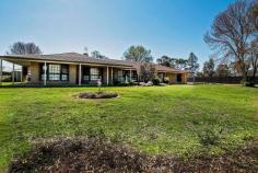  22 Maiden Smith Drive Moama NSW 2731 $650,000 Positioned on an approximate 4837m2 allotment, this commanding property ticks all the boxes. As you approach the tree lined driveway you get a sense of serenity and country living charm, with the bonus of being only minutes from the mighty Murray, RSL Club, sporting facilities and supermarket. Boasting 4 good size bedrooms, all with quality window furnishings, BIR, the master with a large ensuite and WIR, Main bathroom with spa bath, 2 living rooms, the main with a feature fireplace, adding to the country warmth and with the high ceilings you get a sense of grandeur. The sizable chef's kitchen won't disappoint. Fitted out with Bosch appliances, dual wall ovens, stone bench tops and adjoining the dining/ family that features floor to ceiling timber paneling. Plenty of space for entertaining with family and friends. From here the doors open out to the sizable entertaining area, that comes complete with a pizza oven and overlooks the heated swimming pool. There is a 2 meg water allocation, sprinkler system for the gardens, 5 KW solar power as well as a large 4 bay powered shed with concrete floor. An inspection is recommended. Don't miss this one! FEATURES: • 	 Air Conditioning • 	 Built-In Wardrobes • 	 Close To Schools • 	 Close To Shops • 	 Fireplace(S) • 	 Garden • 	 Secure Parking.. 